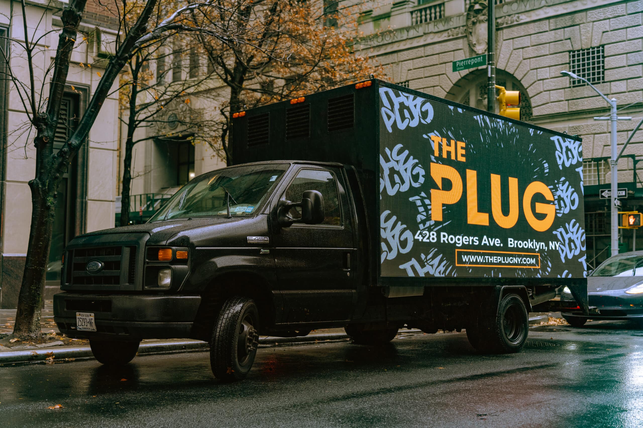 The Plug dispensary truck with sign